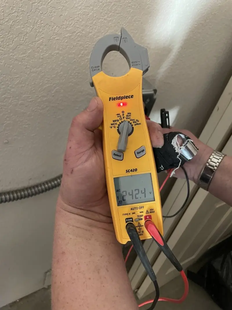 Voltage testing with clamp meter during Electrical Installation Services in Coloma